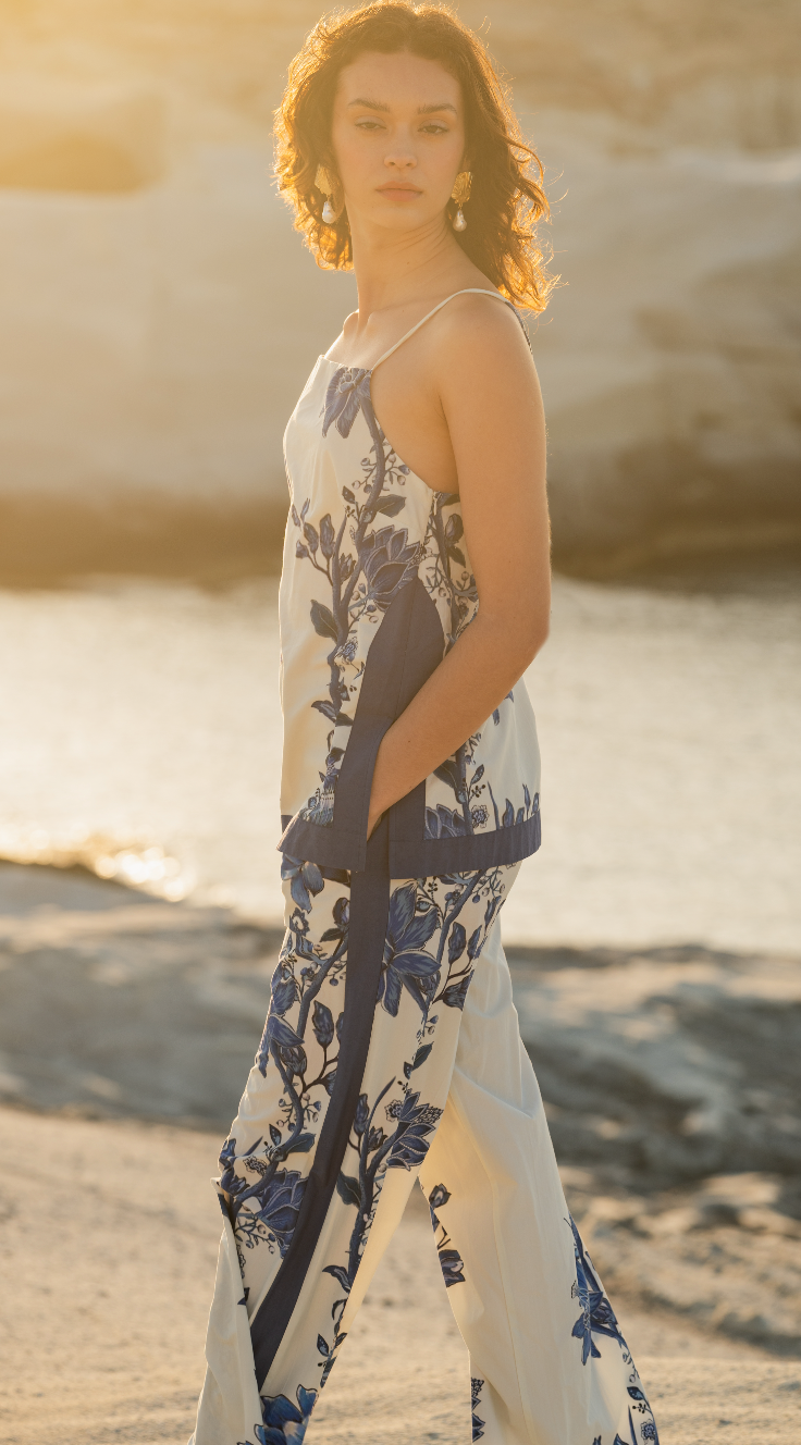 Woman in a floral matching set standing on a beach with a blurred background Calling June