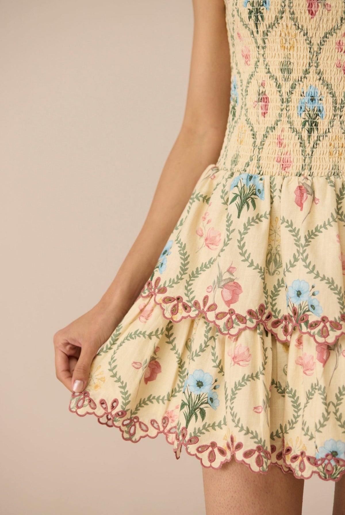 Yellow dress with floral embroidery on a beige background Calling June