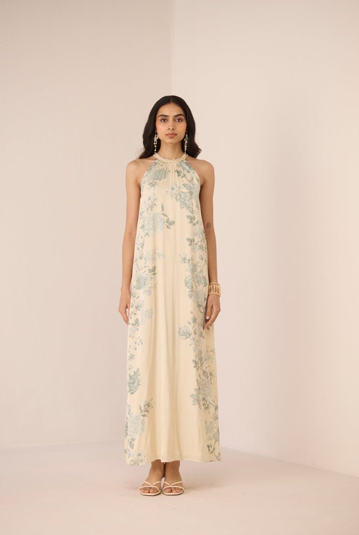 Woman wearing a floral dress on a plain background Calling June