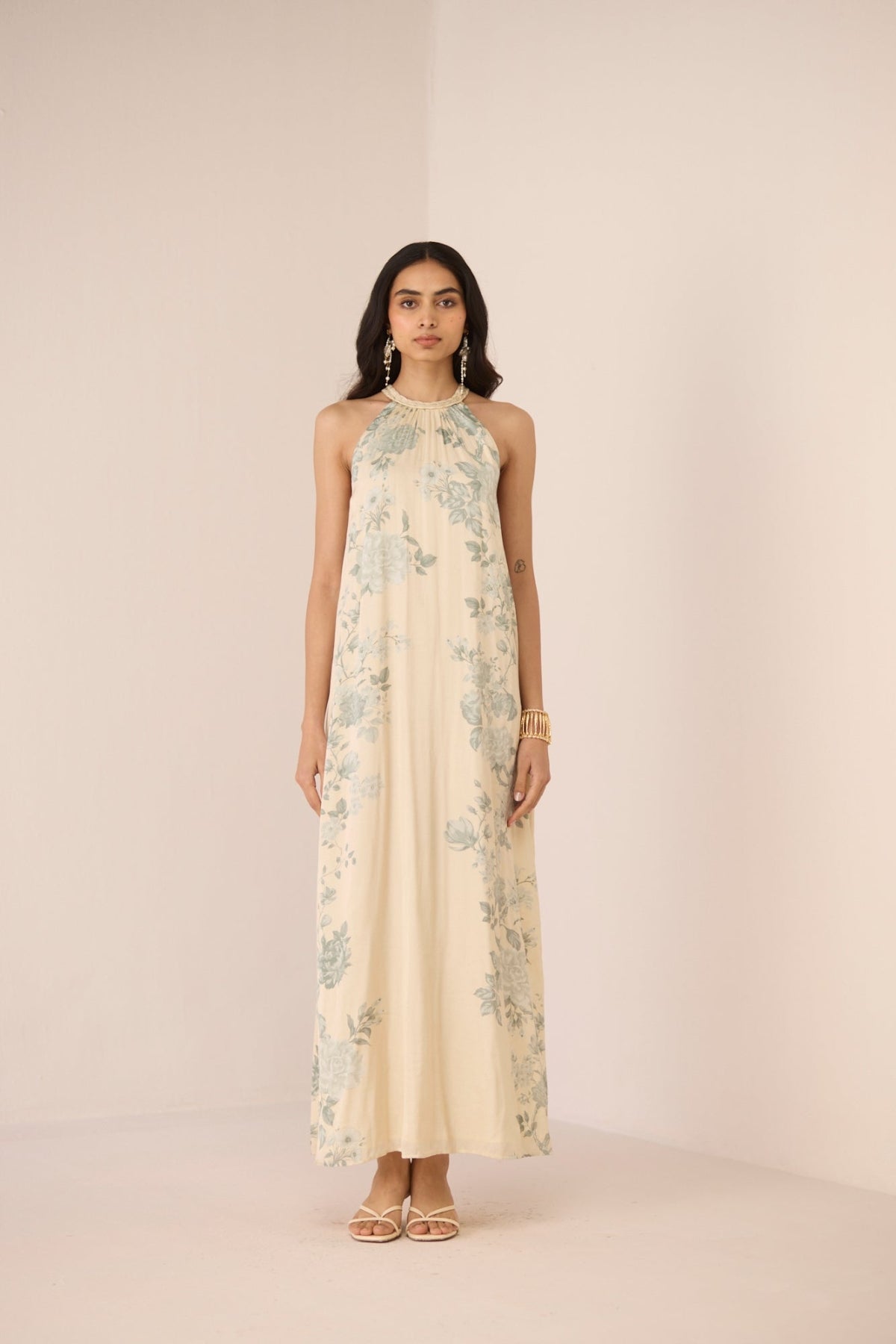 Woman wearing a floral dress on a plain background Calling June