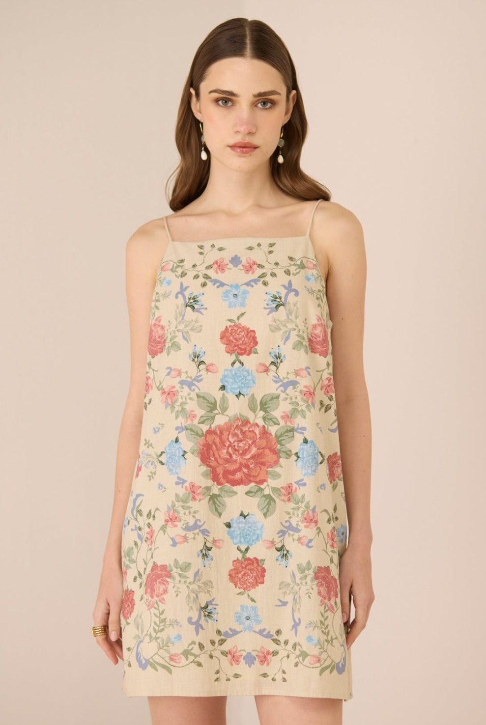 Woman wearing a floral dress against a beige background Calling June