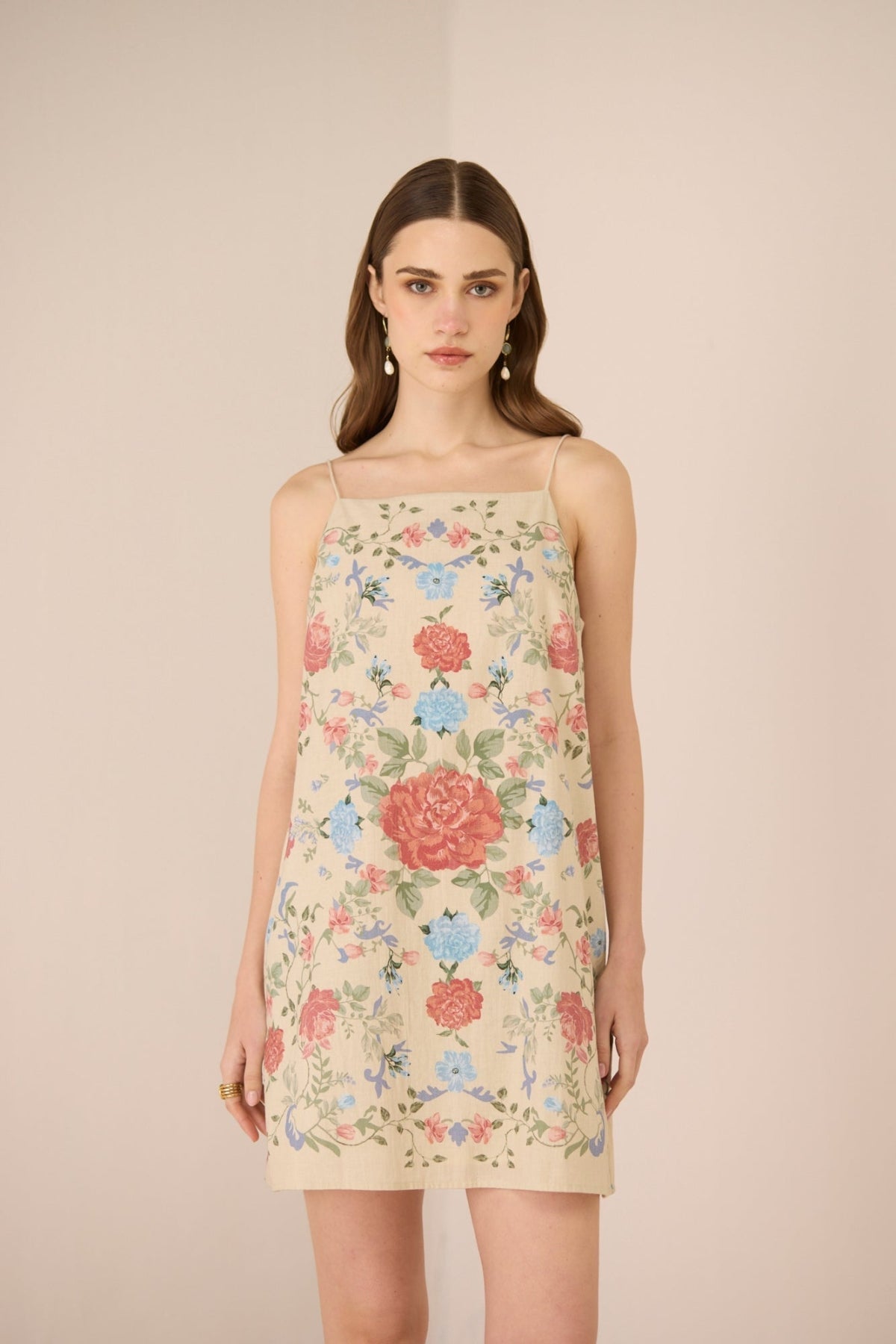 Woman wearing a floral dress against a beige background Calling June