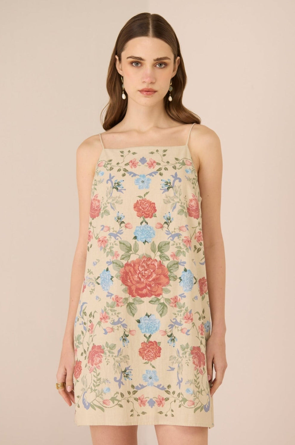 Woman wearing a floral dress against a beige background Calling June