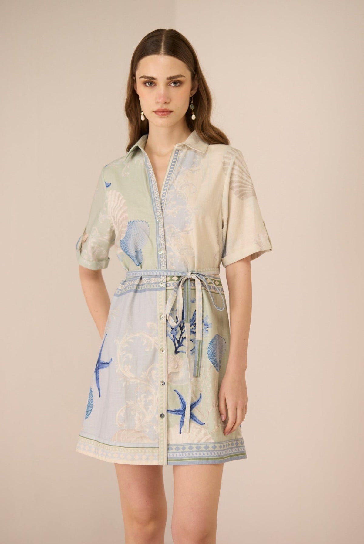 Woman wearing a patterned dress with a neutral background Calling June