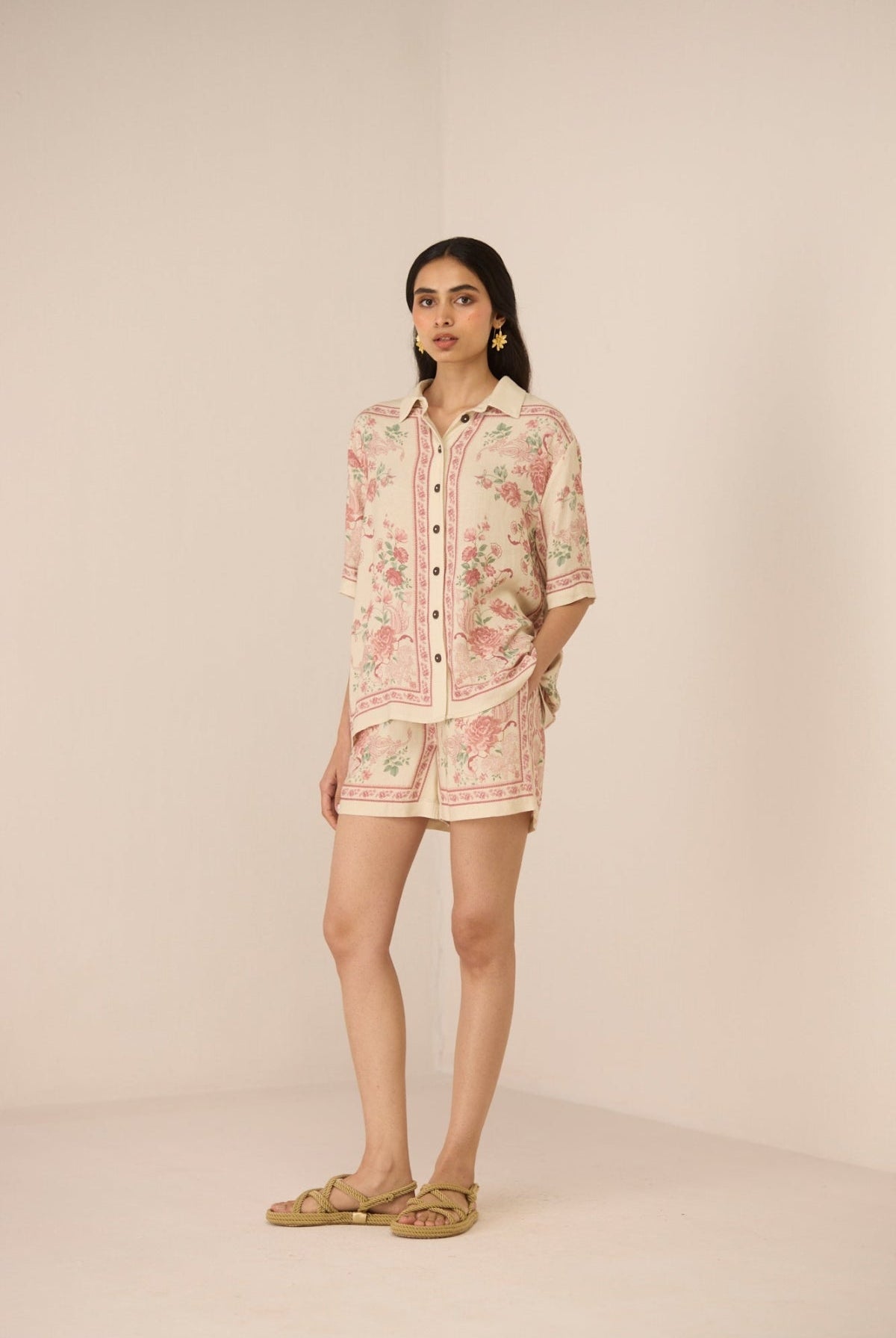 Woman wearing a floral dress with a beige background Calling June