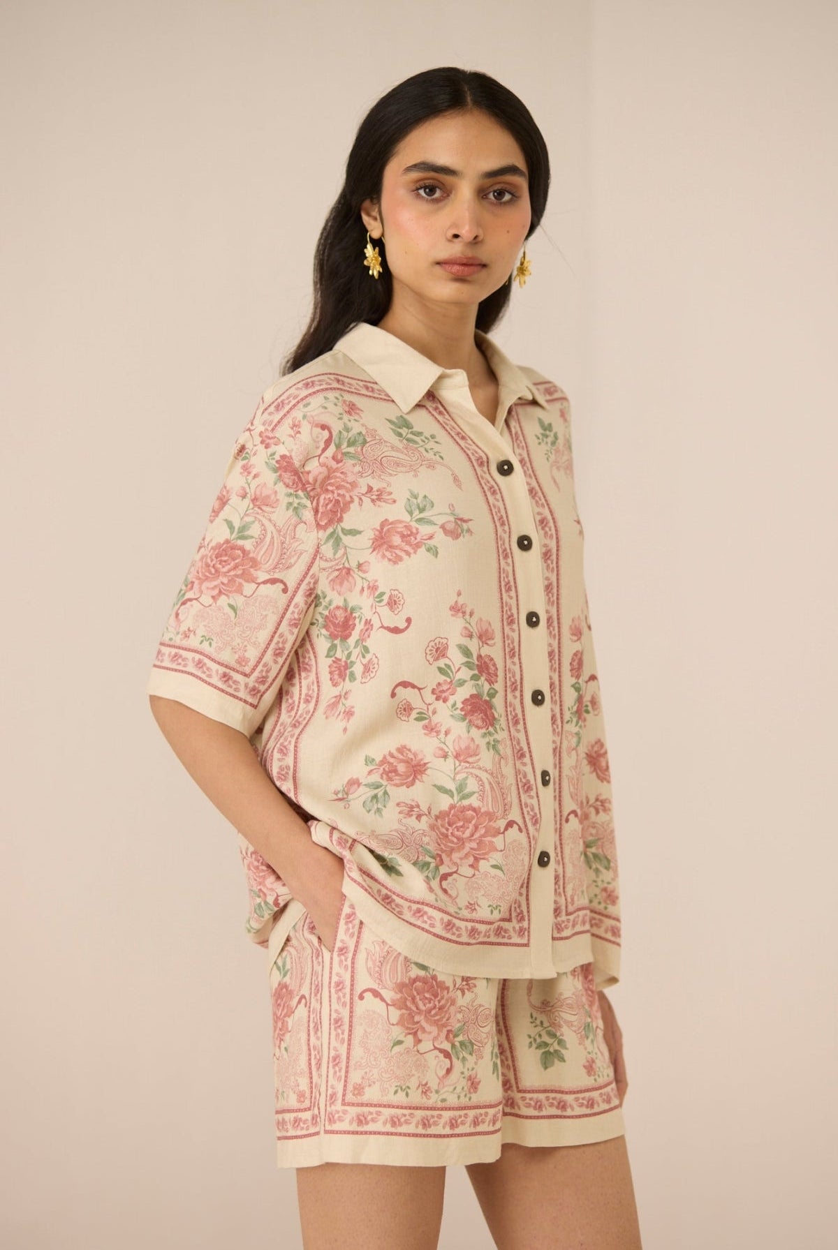 Woman wearing a floral outfit on a beige background Calling June
