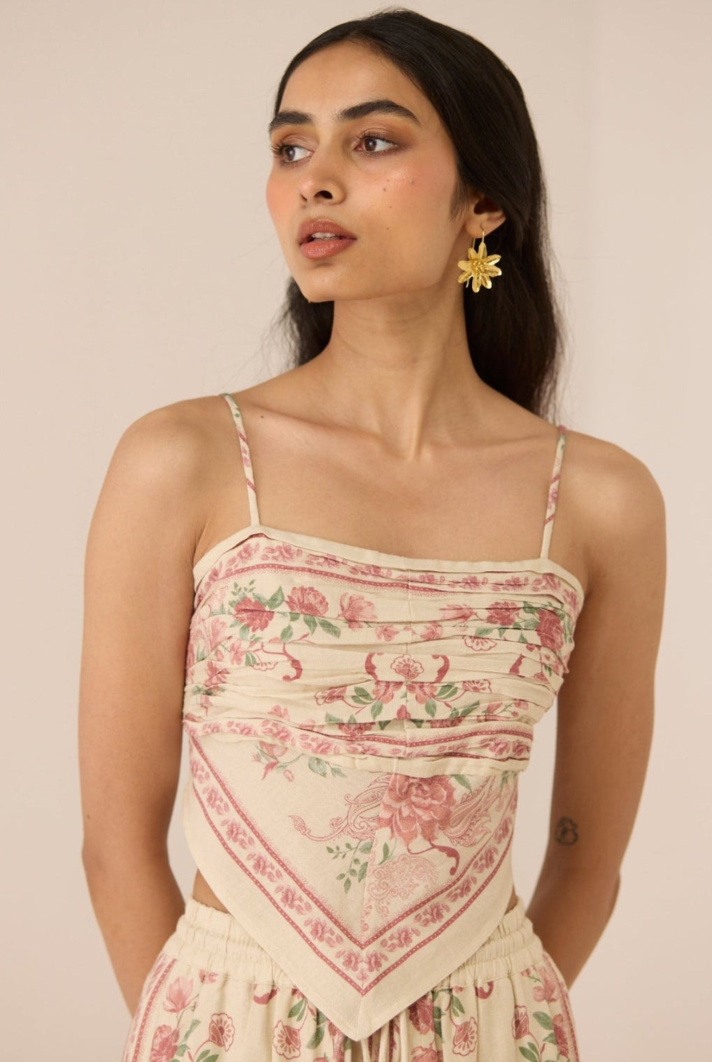 Woman wearing a floral dress with a beige background Calling June