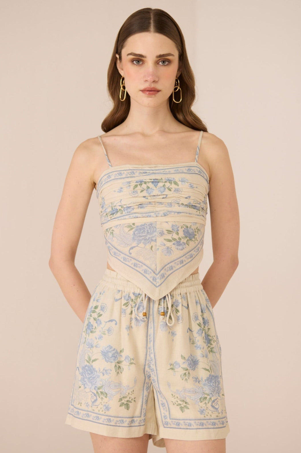 Woman wearing a floral set against a beige background Calling June