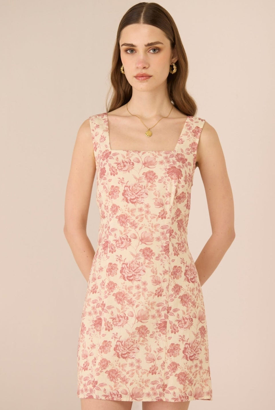 Woman wearing a floral dress against a beige background Calling June