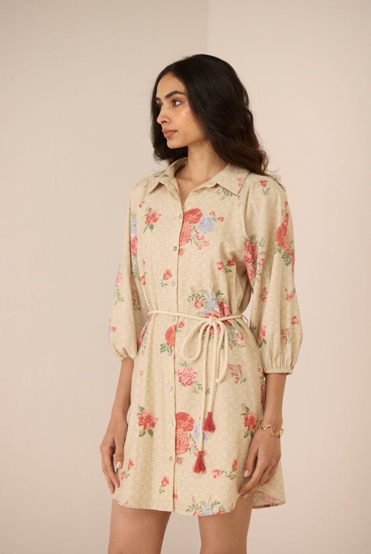Woman wearing a floral dress with a beige background Calling June