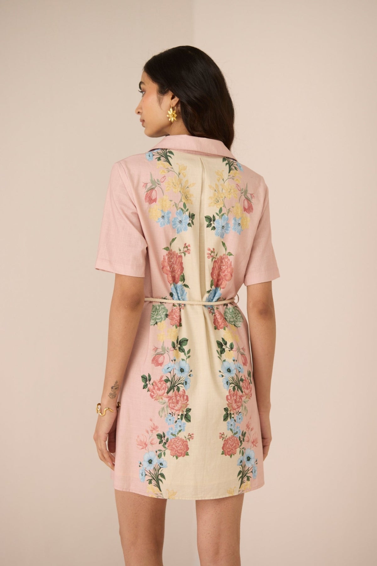 Woman wearing a floral dress with a plain background Calling June