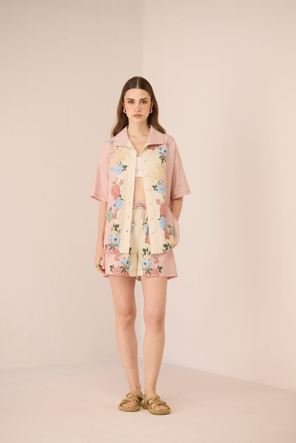 Woman wearing a floral dress with a matching jacket on a beige background Calling June