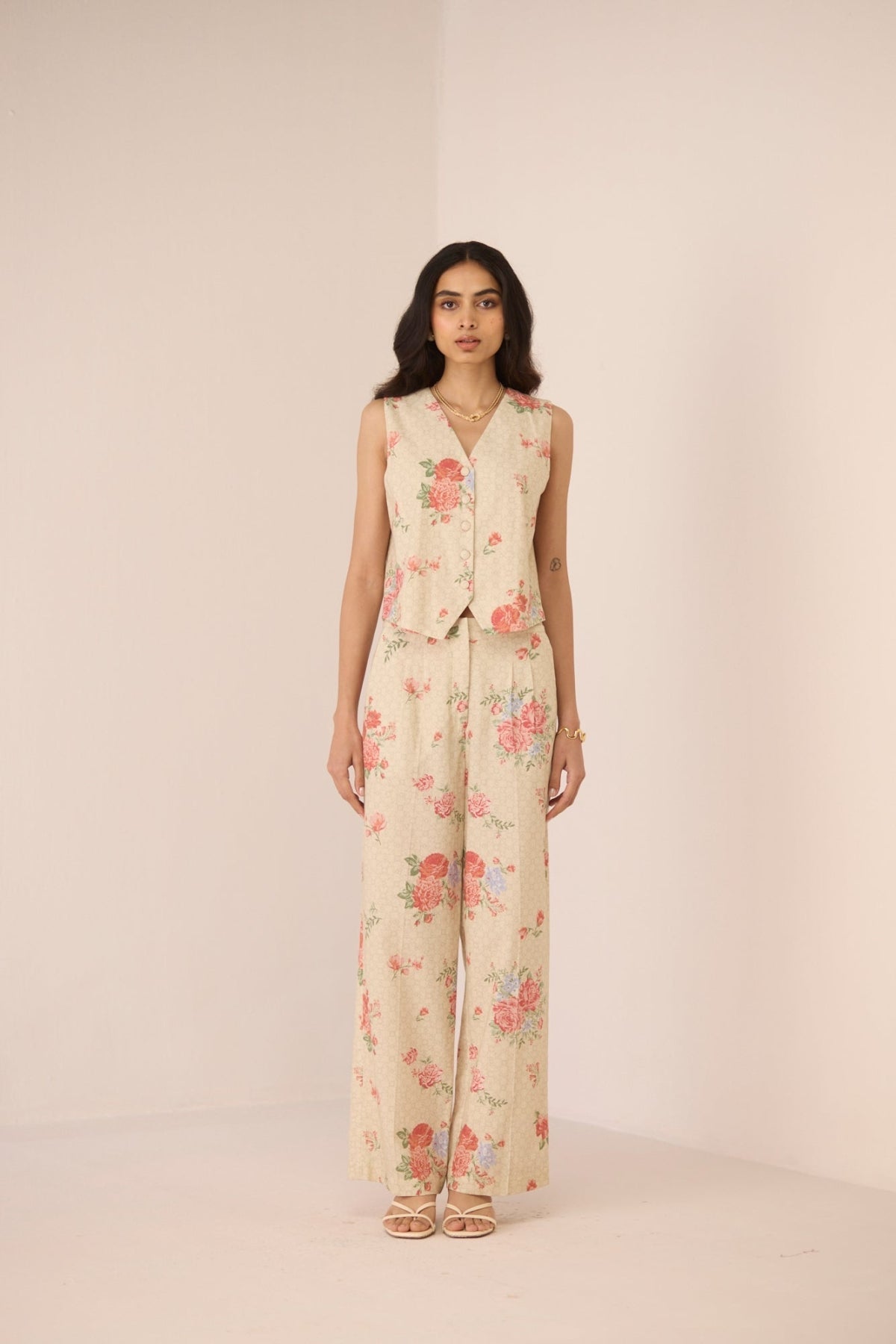 Woman wearing a floral outfit on a beige background Calling June