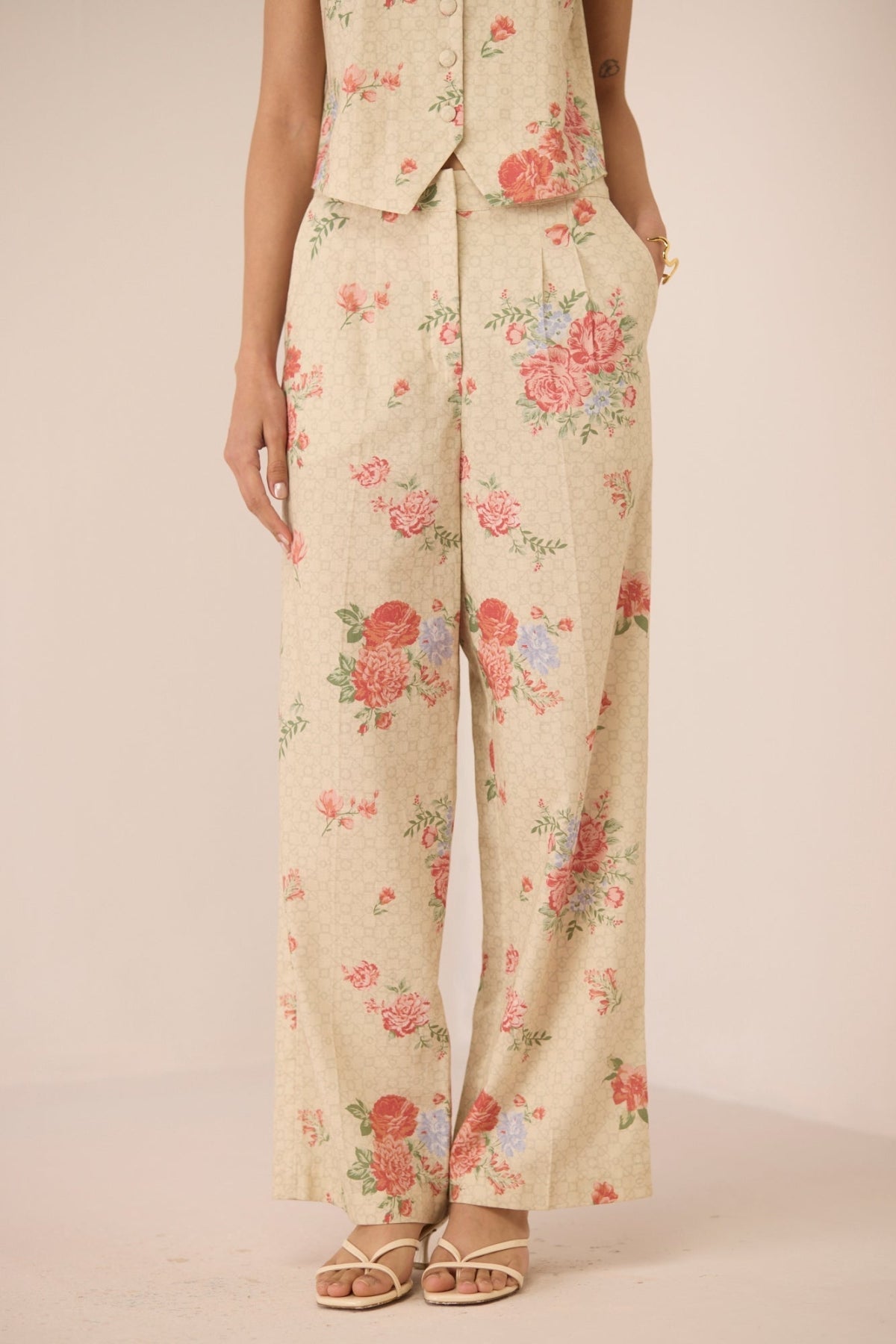 Floral patterned pants on a plain background Calling June