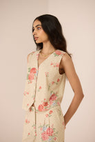 Woman wearing a floral outfit against a plain background Calling June
