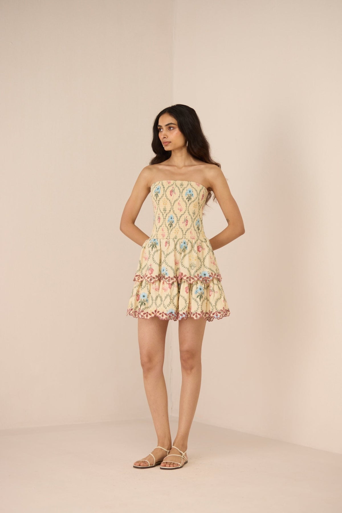 Woman wearing a patterned dress against a plain background Calling June