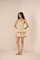 Woman wearing a patterned dress against a plain background Calling June