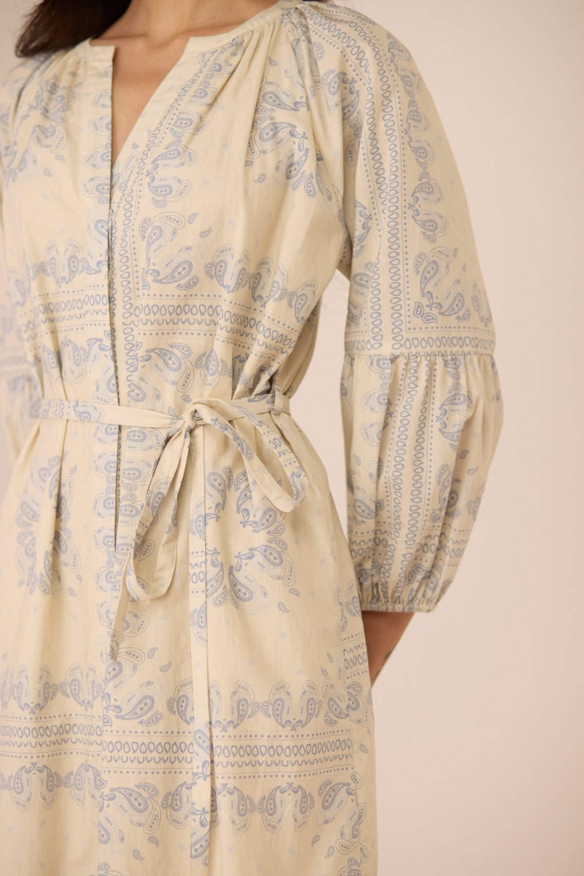 Beige dress with blue pattern on a beige background Calling June