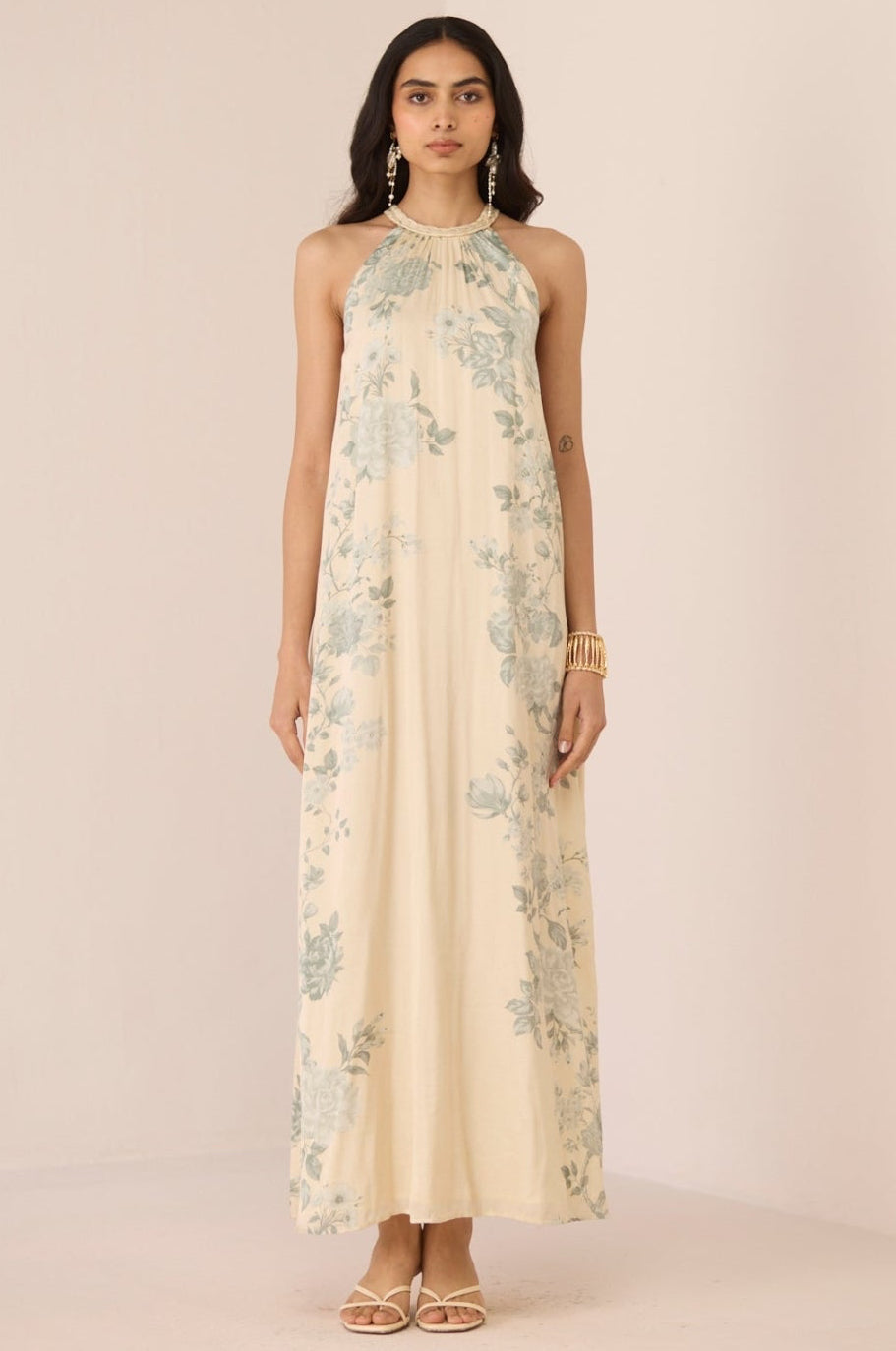 Woman wearing a floral dress on a plain background Calling June