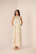 Woman wearing a floral dress against a plain background Calling June