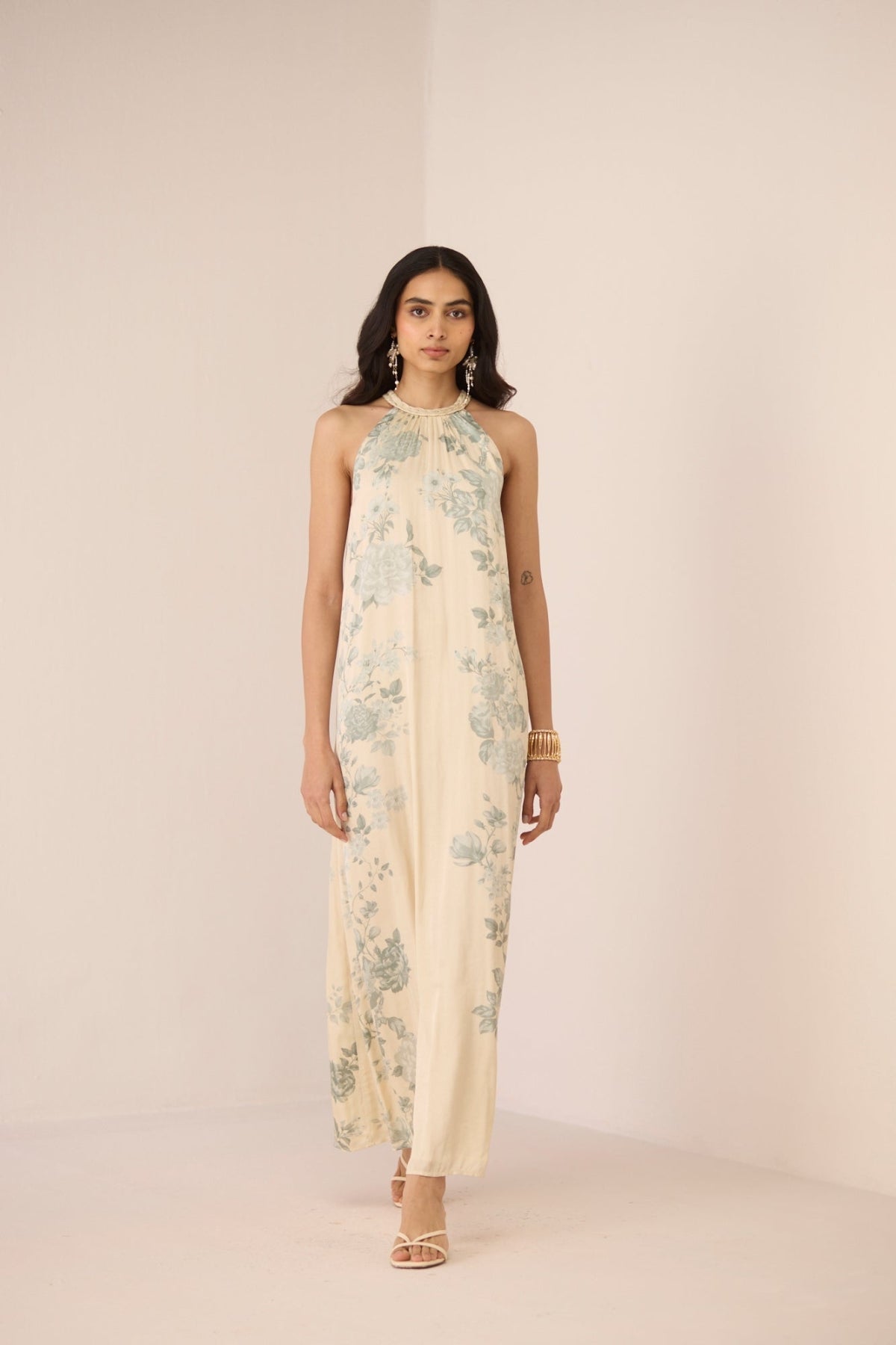 Woman wearing a floral dress on a plain background Calling June