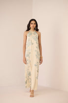 Woman wearing a floral dress on a plain background Calling June