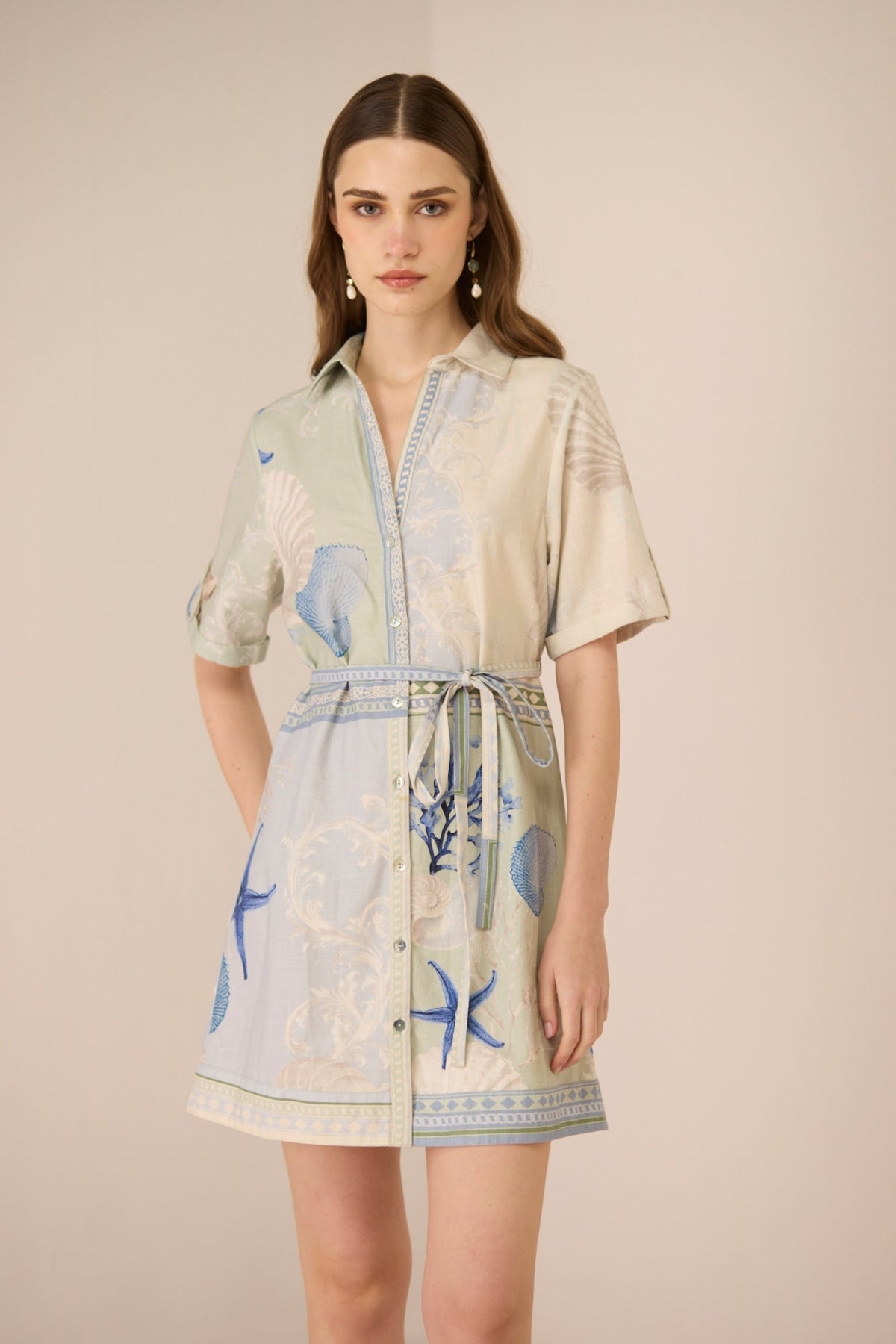 Woman wearing a patterned dress with a neutral background Calling June