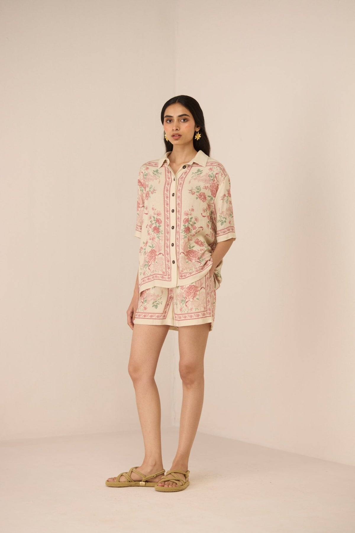 Woman wearing a floral dress with a beige background Calling June