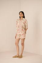 Woman wearing a floral dress with a beige background Calling June