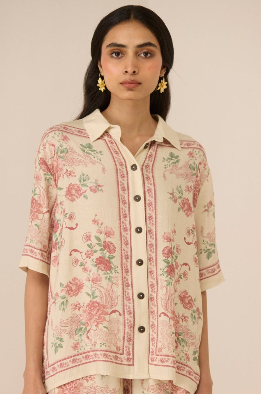 Woman wearing a floral outfit on a beige background Calling June
