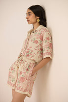 Woman wearing a floral outfit against a plain background Calling June