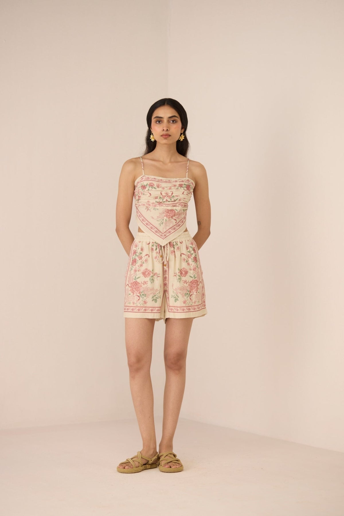 Woman wearing a floral dress with a plain background Calling June