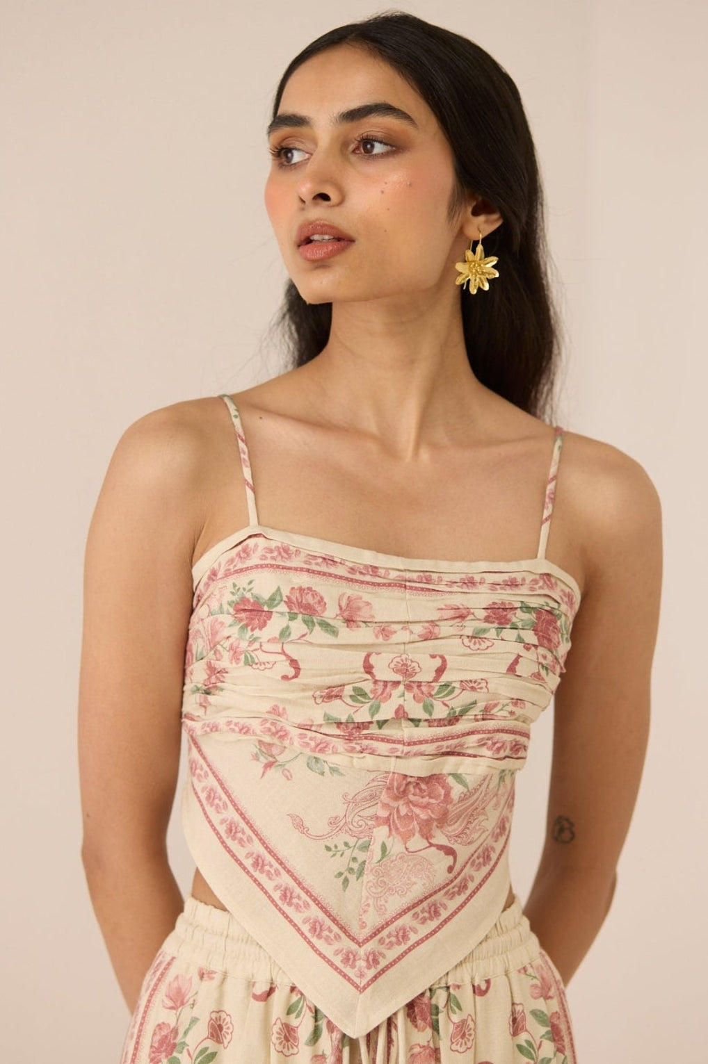 Woman wearing a floral dress with a beige background Calling June