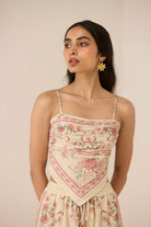 Woman wearing a floral dress with a beige background Calling June