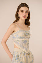 Woman wearing a floral dress with a beige background Calling June