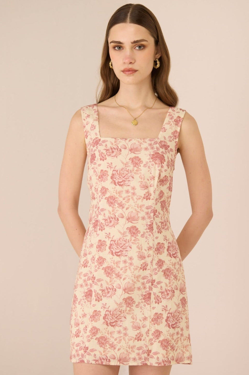 Woman wearing a floral dress against a beige background Calling June