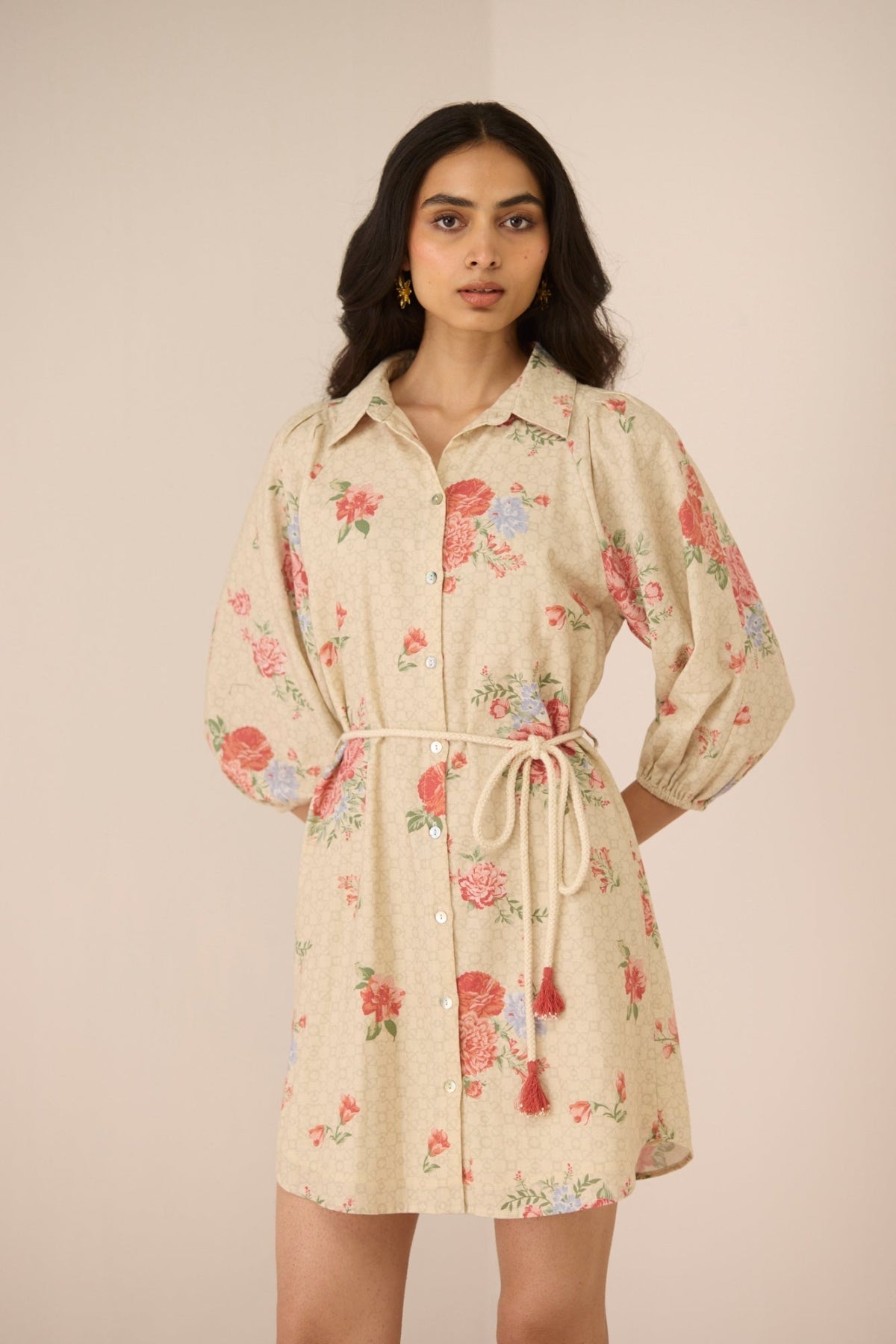 Woman wearing a floral dress with a beige background Calling June