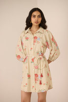 Woman wearing a floral dress with a beige background Calling June