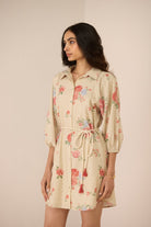 Woman wearing a floral dress with a beige background Calling June