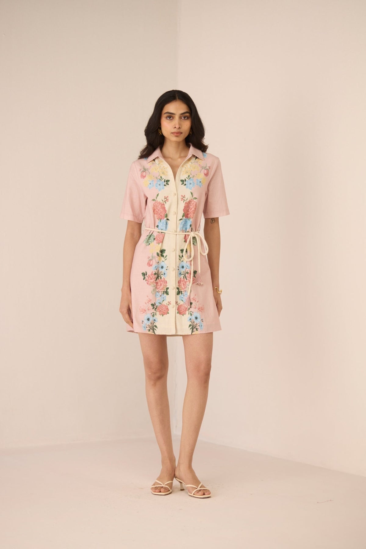 Woman wearing a floral dress on a beige background Calling June