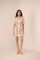 Woman wearing a floral dress on a beige background Calling June