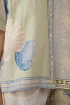 Light green fabric with blue shell design and intricate patterns Calling June